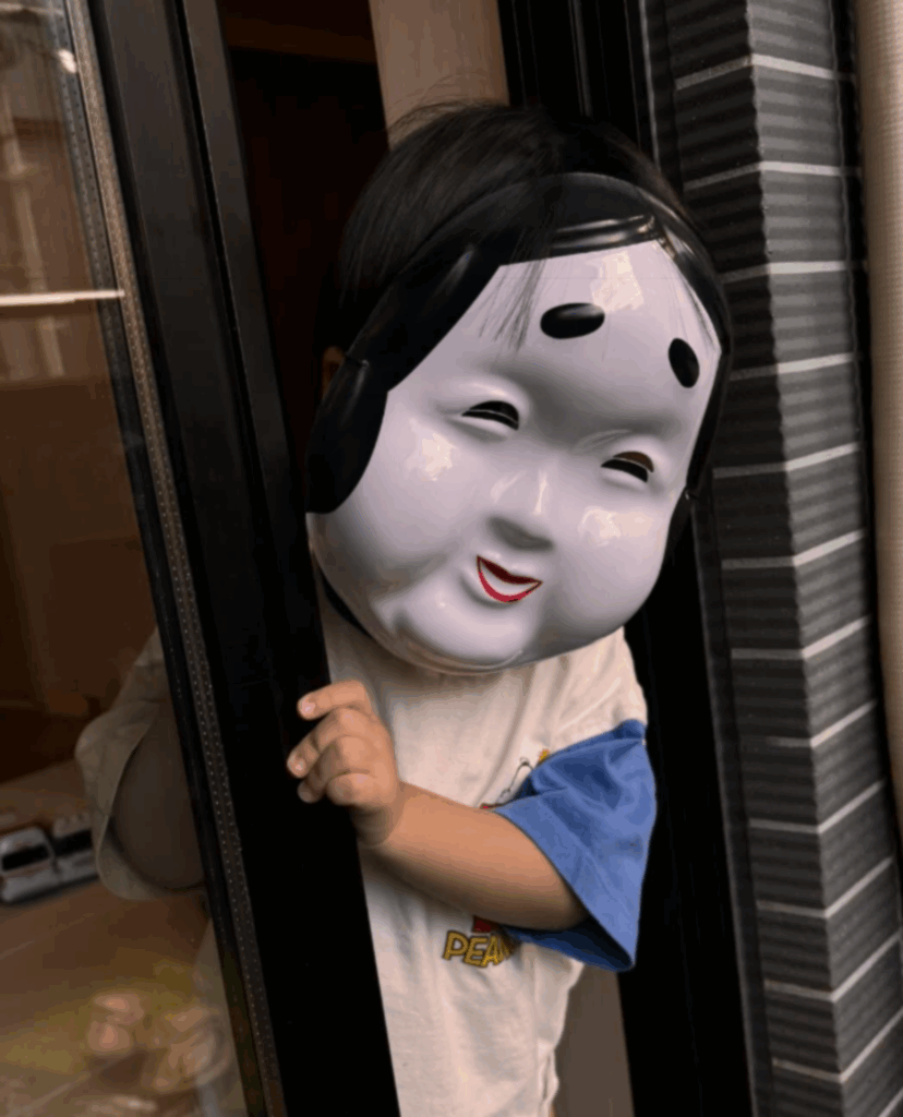 オカメのお面をつけた息子さん（@coco_vanilla13さんより提供）